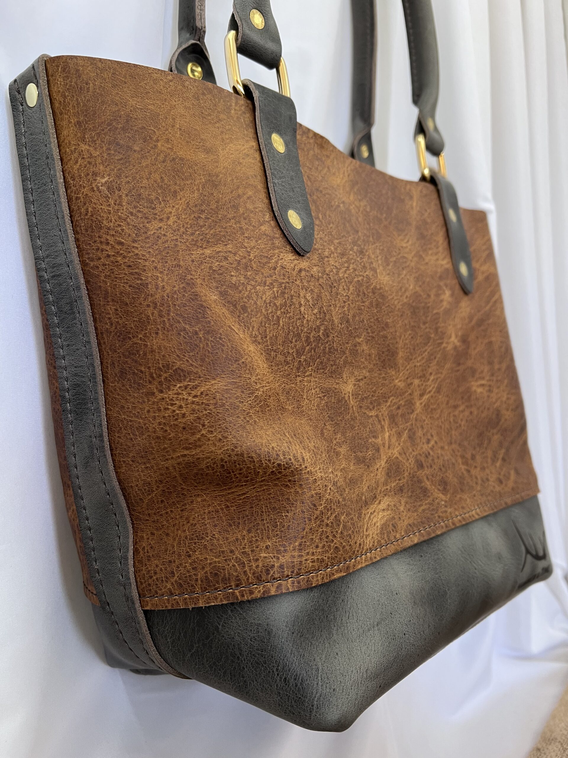 Side of medium brown and grey leather tote